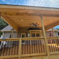 Covered wood deck with ceiling fan and recessed lights