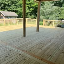 Deck boards extending around covered porch posts