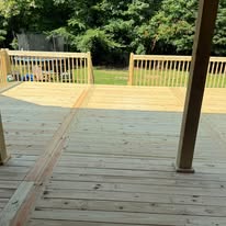 View from the covered porch toward the deck railing and yard