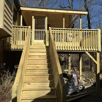 Wood stairs leading to a raised covered deck